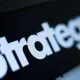 Close-up of the word 'Strategy' in bold white letters on a dark background.