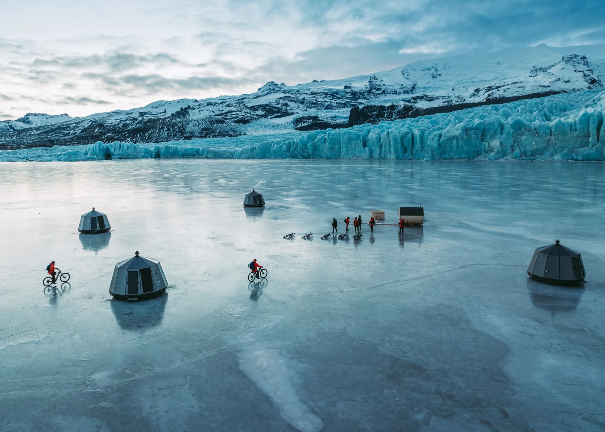 Pods and cyclists on a frozen glacial lagoon