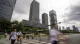 Pedestrians cross a street in a Chinese financial district near high-rise buildings