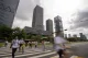 Pedestrians cross a street in a Chinese financial district near high-rise buildings