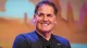 Mark Cuban smiling on stage at an event